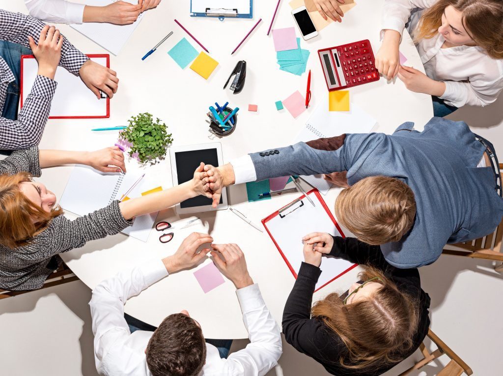 team-sitting-behind-desk-checking-reports-talking-top-view-the-business-concept-of-collaboration-team-work-meeting-1024×765