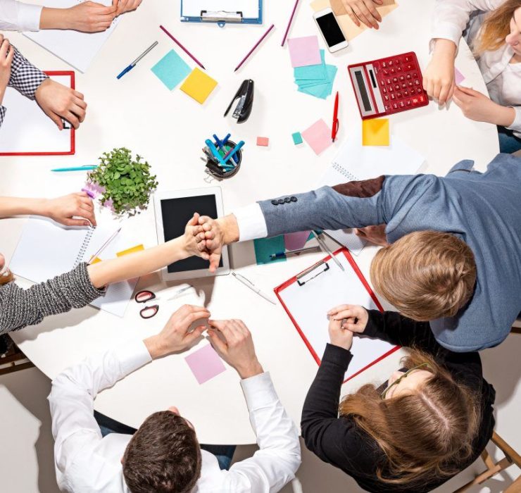 team-sitting-behind-desk-checking-reports-talking-top-view-the-business-concept-of-collaboration-team-work-meeting-1024×765